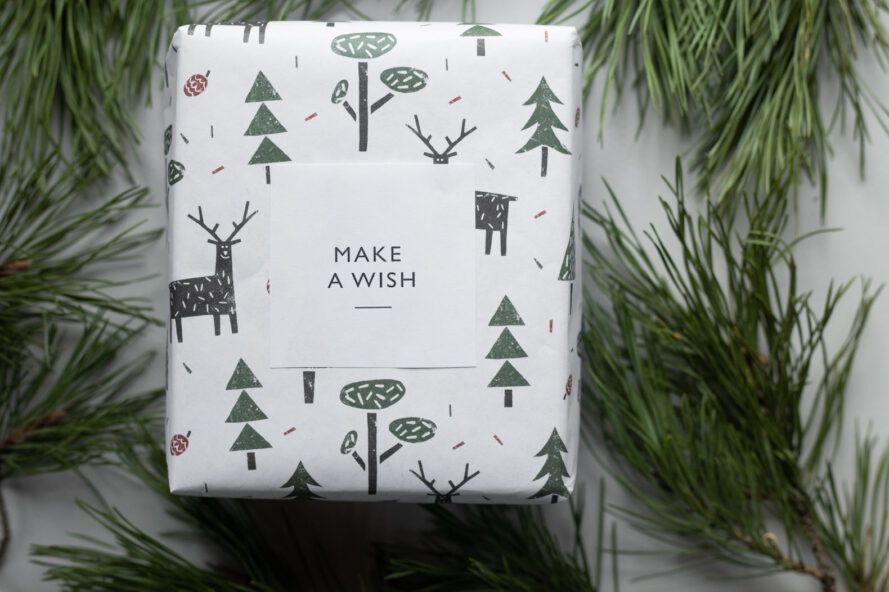 Paper gift wrap with trees and deer on it