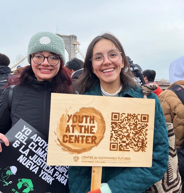 two students holding advocacy signs