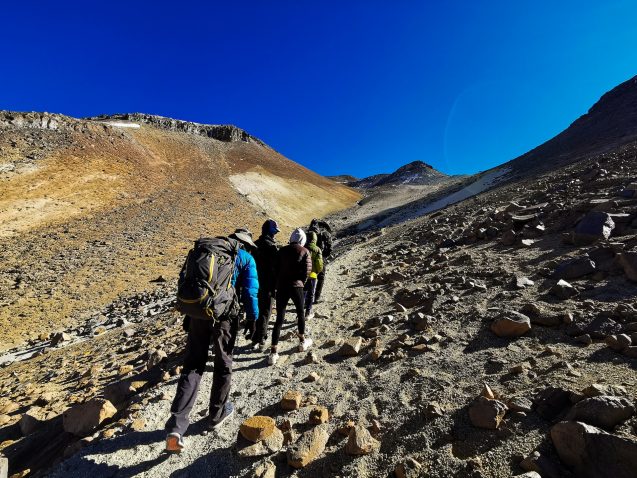people walking up a rocky path