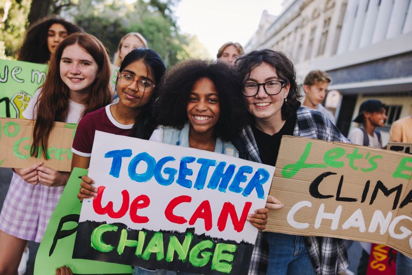 teenagers holding climate action signs