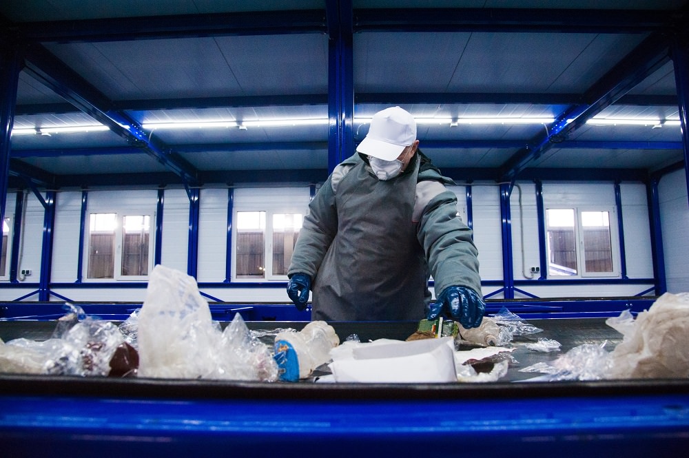 Recycling worker sorting materials