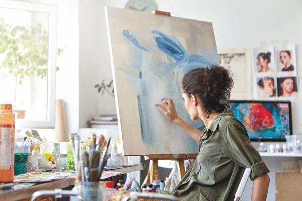 woman painting on a canvas
