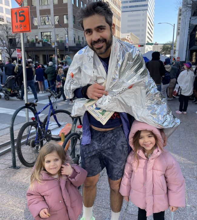 The author after crossing the finish line, posing with his daughters